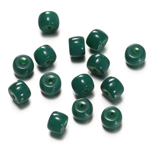 Macro shot of dark green cylinder resin beads with center holes for DIY jewelry making