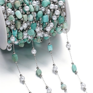 Detail of colorful stone chips and pearls on stainless steel chain for DIY jewelry