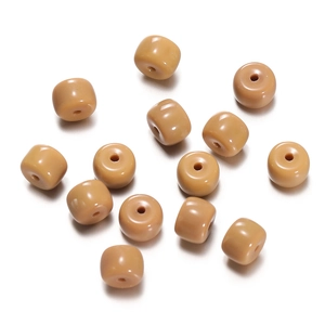 Macro shot of khaki cylindrical glass spacer beads for DIY bracelet and jewelry making
