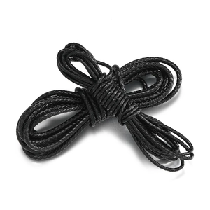 Macro view of black braided leather cord bundle for DIY jewelry making and crafts