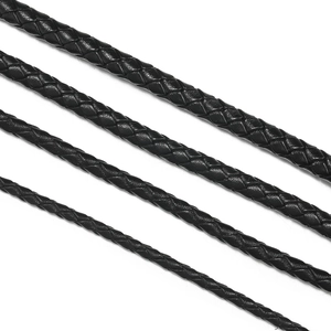 Macro detail of black braided leather cords in multiple thicknesses for DIY jewelry