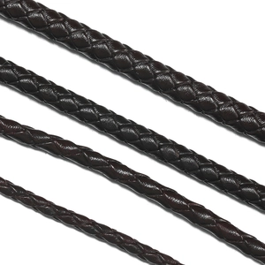 Macro detail of dark brown braided leather cords in four different thickness levels