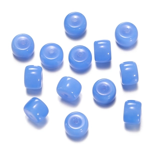 Detailed close-up of light blue cylindrical glass beads for DIY handmade jewelry crafts