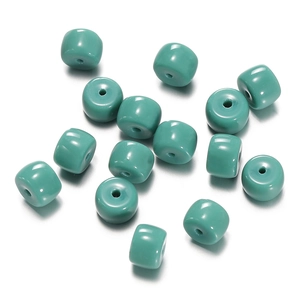 Close-up of vibrant turquoise cylindrical glass spacer beads for DIY jewelry making
