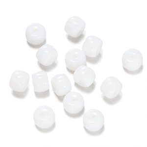 Macro shot of white cylinder glass beads with smooth finish and central hole for DIY jewelry