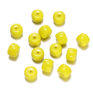 Detailed view of lemon yellow cylinder glass beads for DIY bracelet making projects