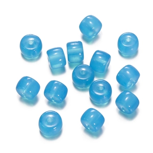 Macro detail of blue translucent glass cylinder beads for DIY jewelry making and crafts