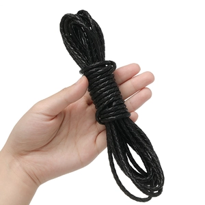 Braided black leather cord for DIY jewelry making held to show its flexibility and texture