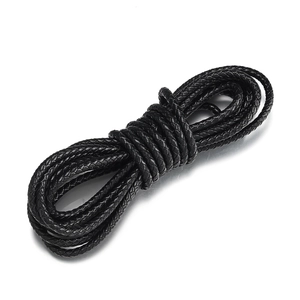 Close-up of black braided leather cord showing detailed texture and woven structure