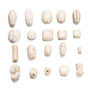 Off-white synthetic turquoise beads with brown marble texture in various geometric shapes