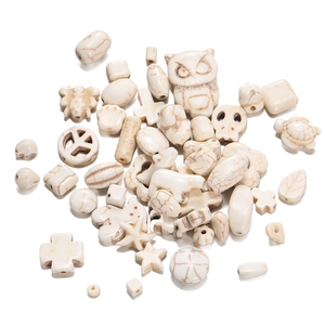 Assorted white howlite stone beads in owl, skull, and cross shapes for DIY jewelry making