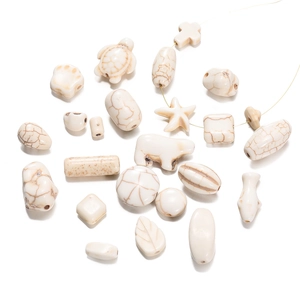 Macro detail of white howlite stone beads showing natural marble textures for DIY jewelry making