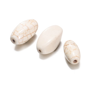 Macro shot of oval white turquoise beads with natural brown veins for DIY jewelry making