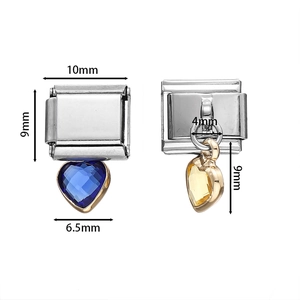 Macro detail of 10mm x 9mm stainless steel Italian charm links with heart-shaped gemstones
