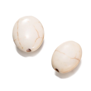 Macro view of oval white howlite beads with brown marble texture and pre-drilled holes