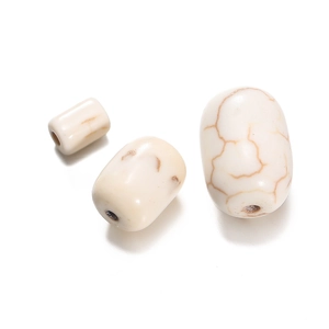 Macro view of white turquoise beads with brown mineral veins for DIY jewelry making
