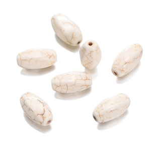 Close-up of oval white turquoise beads with natural marble texture for DIY jewelry making