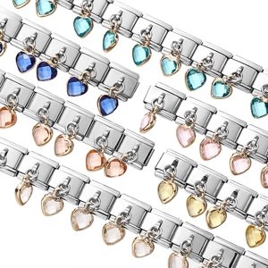 Close-up of stainless steel bracelet links with various colorful crystal heart charms