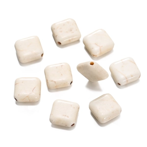 Close-up of nine square white turquoise stone beads with marble texture for DIY jewelry