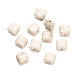 Macro view of square white howlite stone beads with brown marble texture for DIY jewelry
