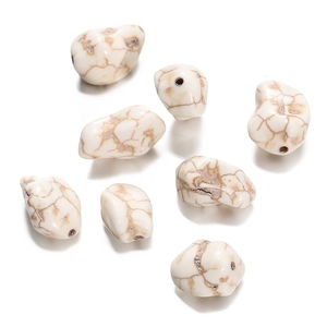 Macro view of irregular white howlite stone beads with natural brown veins for DIY jewelry