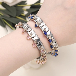 Detail of Italian style link bracelets featuring faceted pink and dark blue heart charms