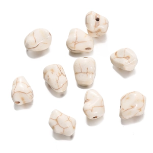 Macro view of nine irregular white turquoise beads with natural brown mesh texture and holes