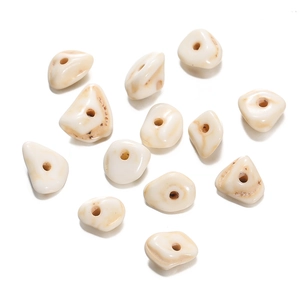 Macro shot of irregular white turquoise skull beads with natural brown veins for DIY jewelry