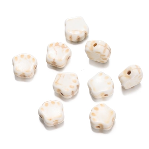 Close-up of nine cute ceramic cat paw loose beads with holes for DIY jewelry making