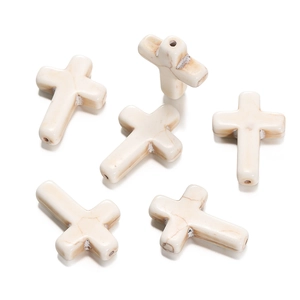 Macro detail of cross-shaped white turquoise synthetic beads with natural marble texture