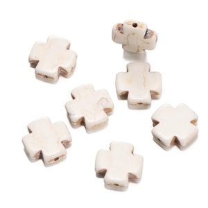 Detailed close-up of white howlite stone cross beads for DIY jewelry making