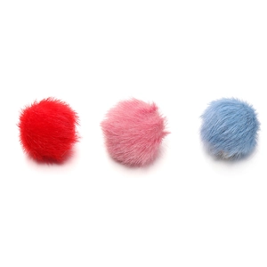 Detailed macro view of 17mm fluffy faux mink fur balls in red, pink, and blue colors