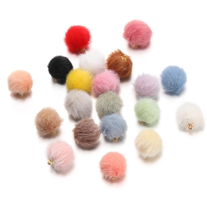 Close-up of colorful 17mm faux mink fur pom-pom charms with golden metal loops for DIY