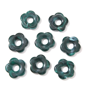 Macro detail of dark green marble patterned acrylic flower beads for jewelry making