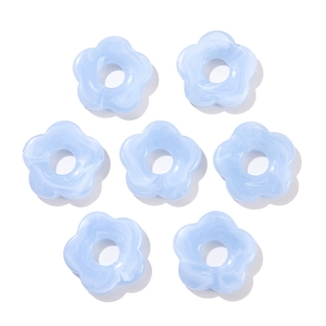 Detailed close-up of 26mm blue acrylic five-petal flower beads with marble texture