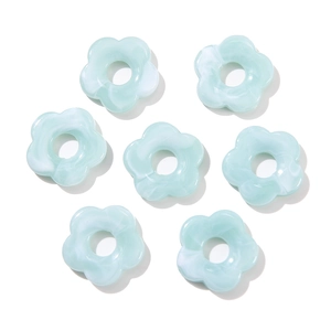 Macro view of 26mm mint blue acrylic flower beads with marble texture for DIY jewelry
