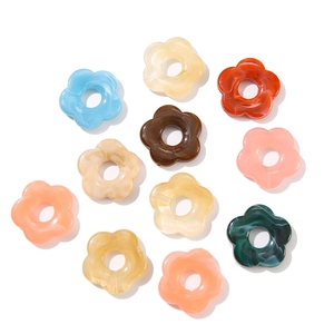 Macro shot of 26mm acrylic flower beads with marble texture for DIY jewelry making