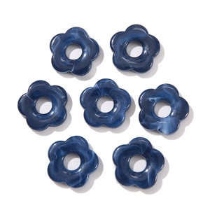 Top view of blue marble acrylic flower beads for DIY jewelry and earring crafts