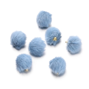 Macro shot of 7 light blue faux mink fur pom-pom charms with golden loops for DIY jewelry