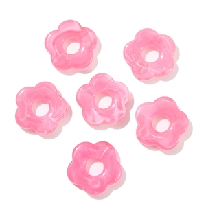 Macro shot of 26mm pink acrylic flower beads with marble texture for DIY jewelry making