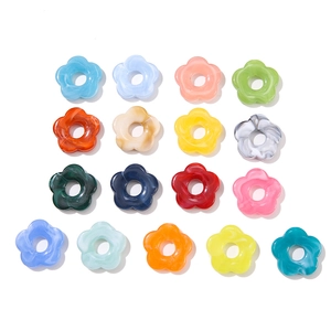 Macro view of 26mm acrylic flower beads with marble ink texture and center holes