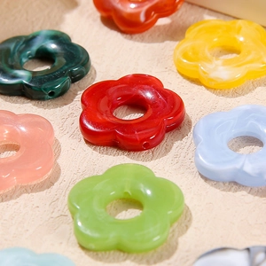 Macro detail of multi-colored acrylic flower beads for DIY jewelry and crafts