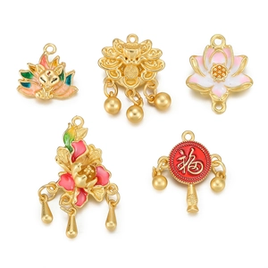 Detailed view of handmade enamel pendants with lotus and lucky charm motifs
