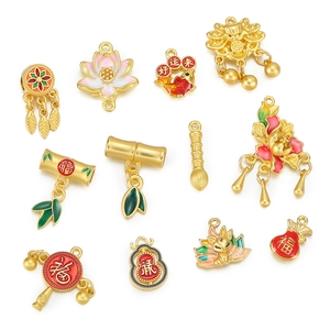 Flat lay of traditional Chinese enamel charms including lotus and koi for jewelry making