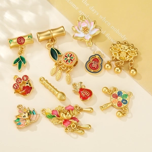 Detailed close-up of traditional Chinese gold charms with colorful enamel pendant collection