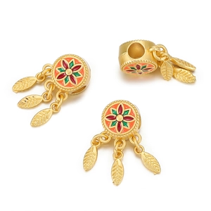 Macro view of gold-plated enamel beads with floral patterns and hanging leaf charms
