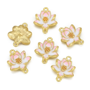 Detailed macro view of lotus pendants with gold plating and pink enamel finish for DIY jewelry