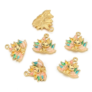 Detail view of colorful enamel fox charms for DIY jewelry with matte gold back