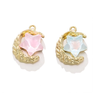 Detailed view of moon and star charms with gold lava texture and opal-like resin stars