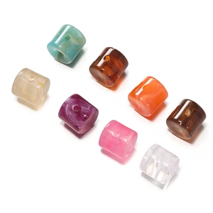 Macro view of colorful acrylic cylinder beads with marble texture for DIY jewelry
